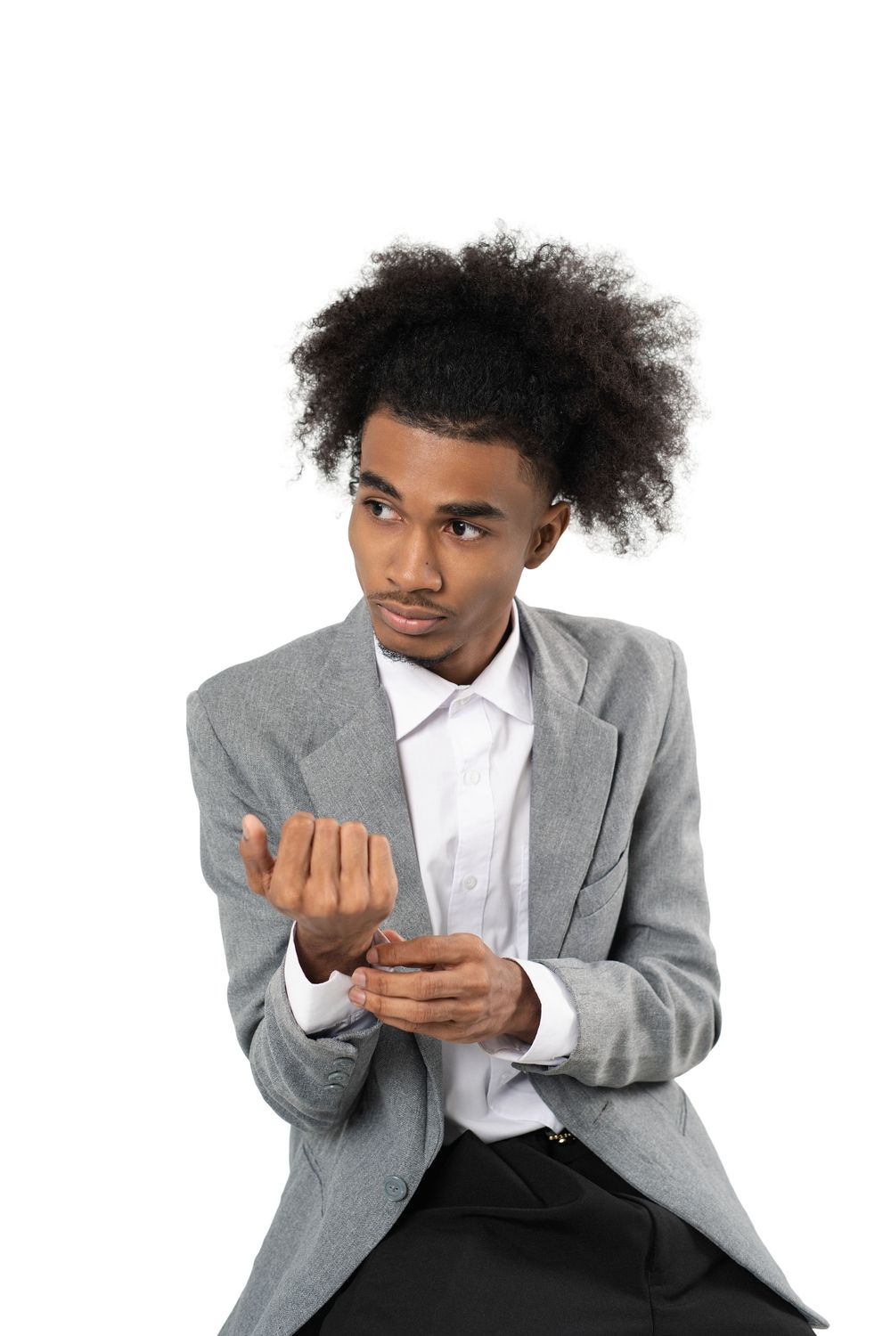 Person in grey suit jacket and white shirt making expressive hand gestures against white background.