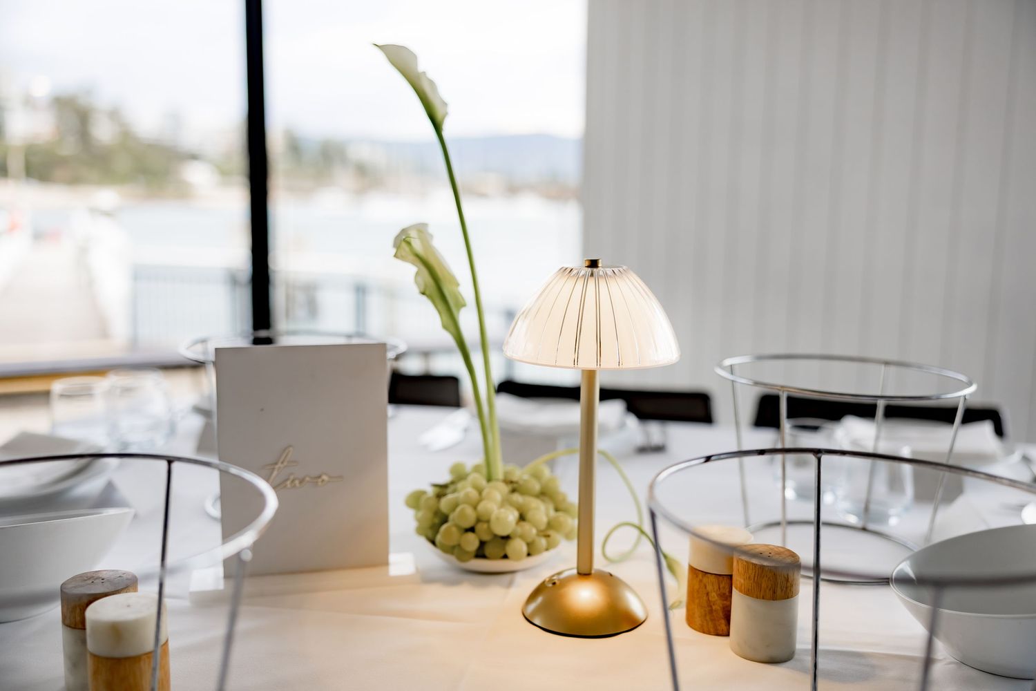 A series of minimalist interior design photos showing white furniture, table lamps, and decorative vases in natural light.
