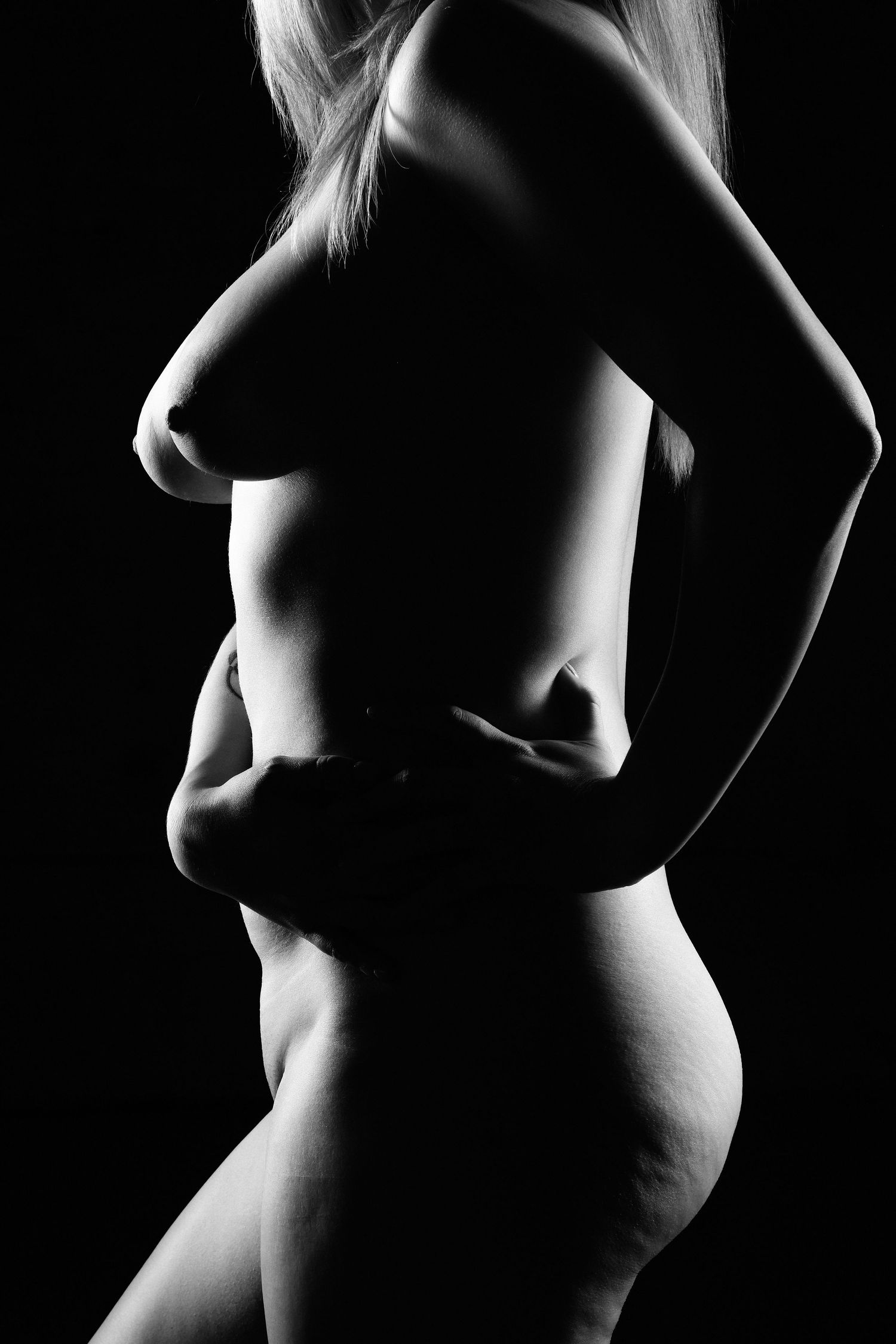 David G Holt Photography - Dramatic black and white silhouette highlighting feminine curves and shadows.