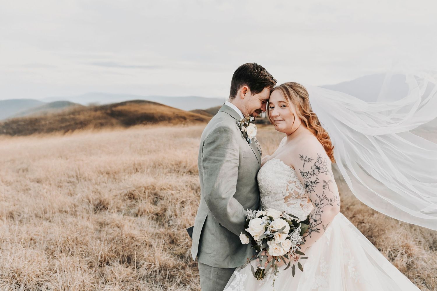 Romantic sunset portraits of bride and groom on a golf course with moody winter clouds
