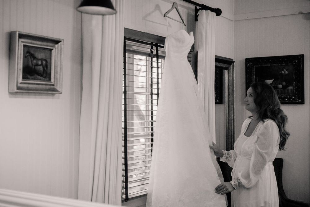 Black and white photos showing wedding dress preparation moments.