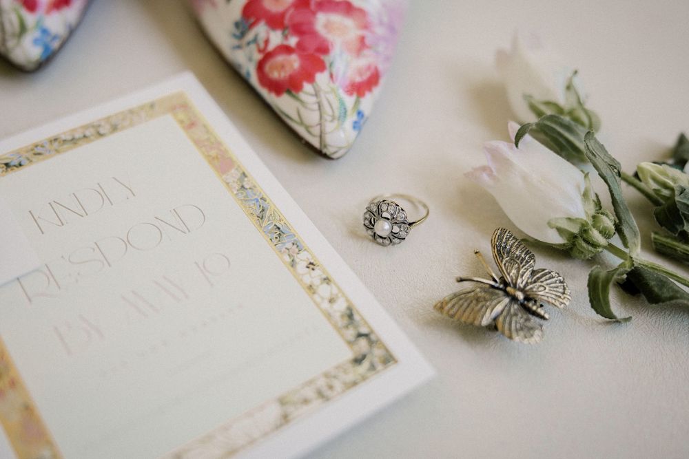 Wedding invitation suite with delicate floral details and decorative elements.