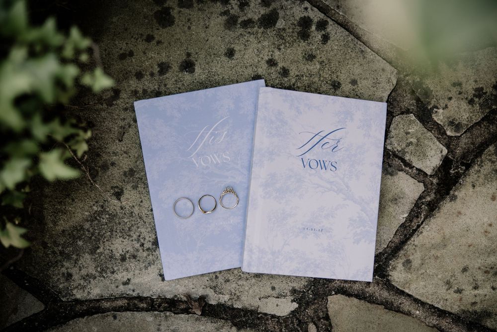 Several white paper notes scattered on rough concrete ground with dark vignette edges in the frame.