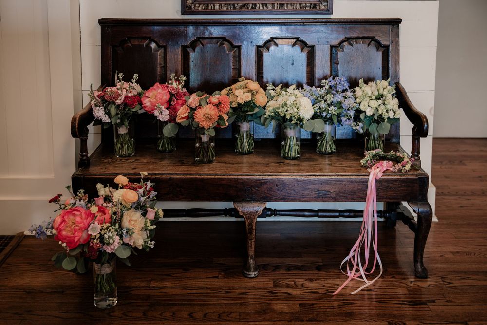 Wedding altar decorated with colorful floral arrangements and ribbons.