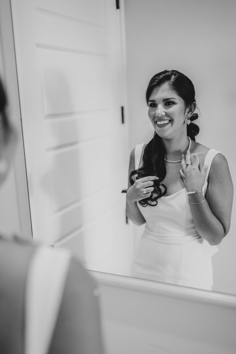 Black and white series of mirror reflections showing joyful wedding day preparations.