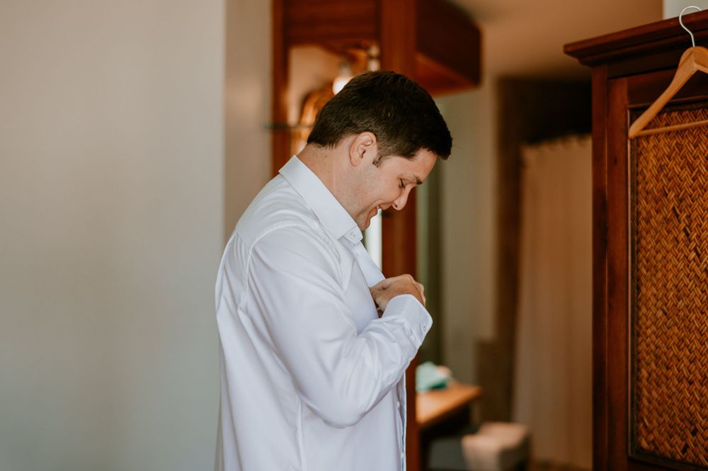 Close up of formal dress shoes and clothing during wedding preparation.