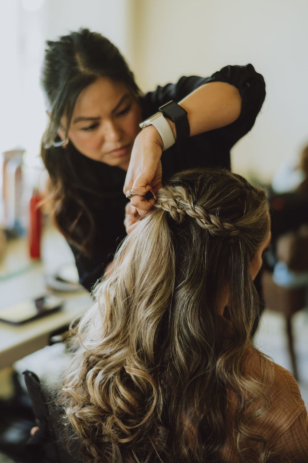 Hair styling session showing intricate braiding technique in progress.