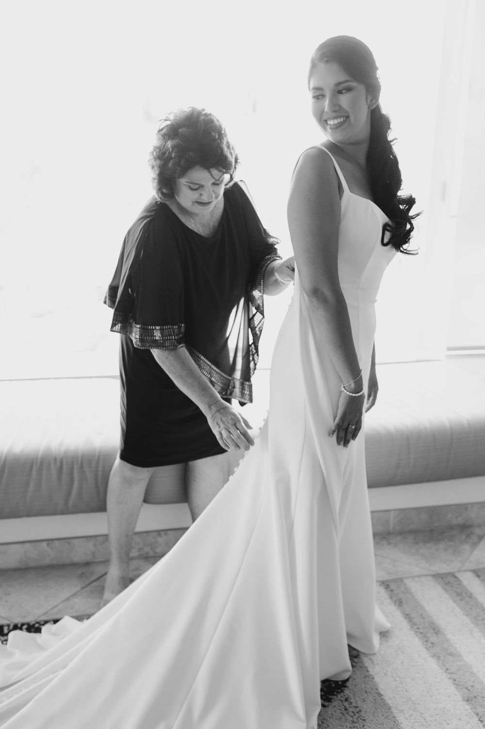 Black and white photos showing wedding dress adjustments and preparations.