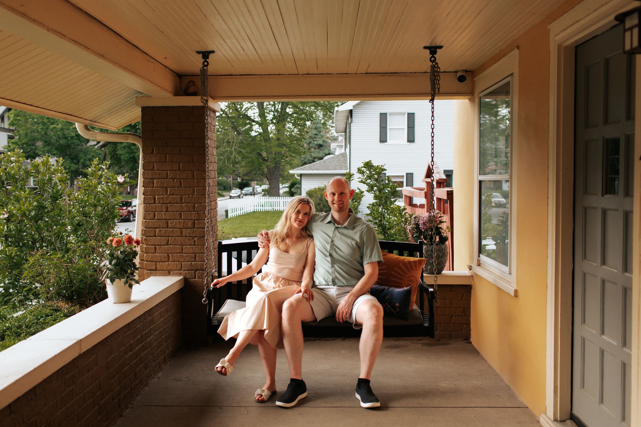 A series of connected photos showing people relaxing on a covered porch with white columns and wooden railings.