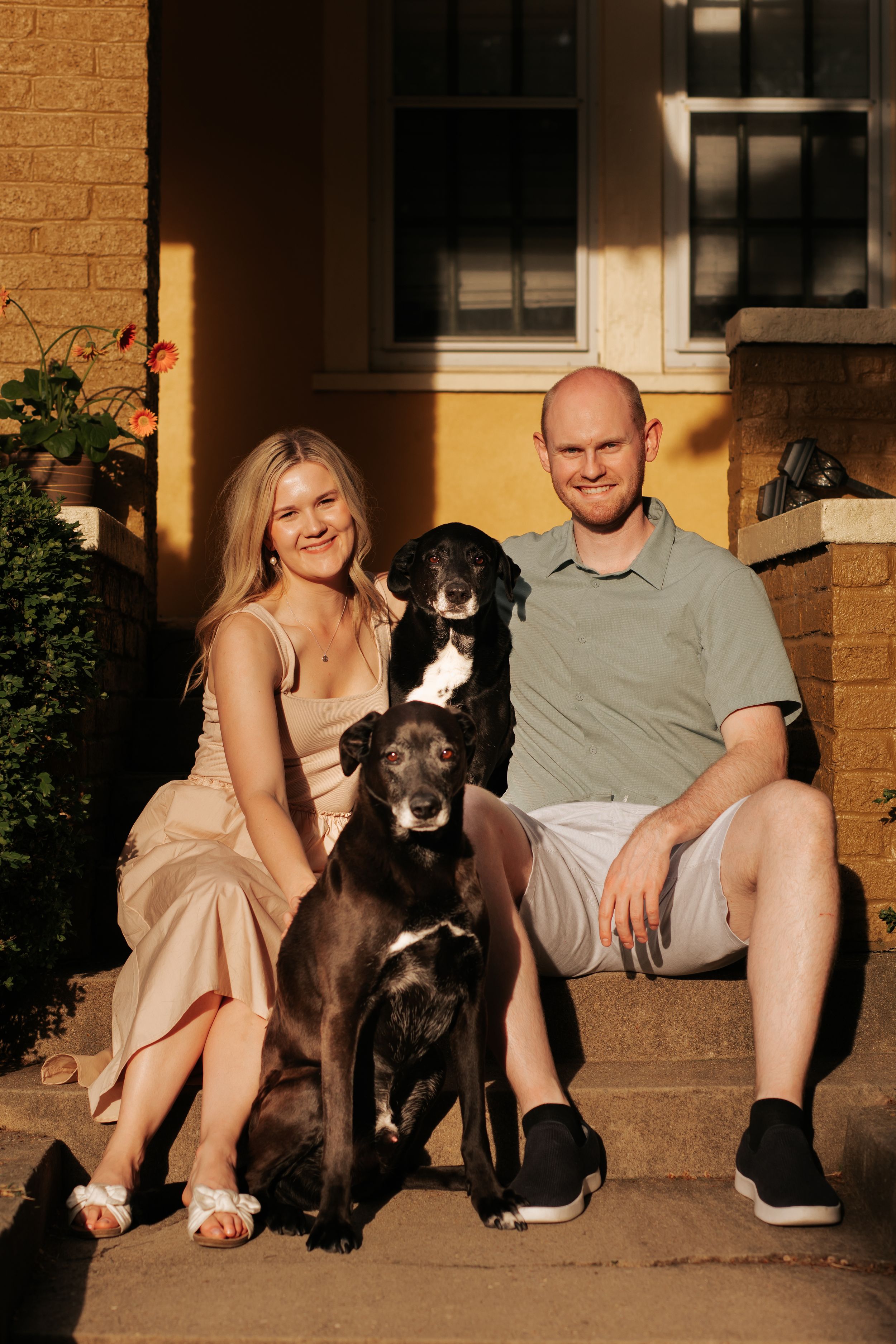 A couple sits on a porch with their dark-colored dog in a series of casual outdoor photos at sunset.
