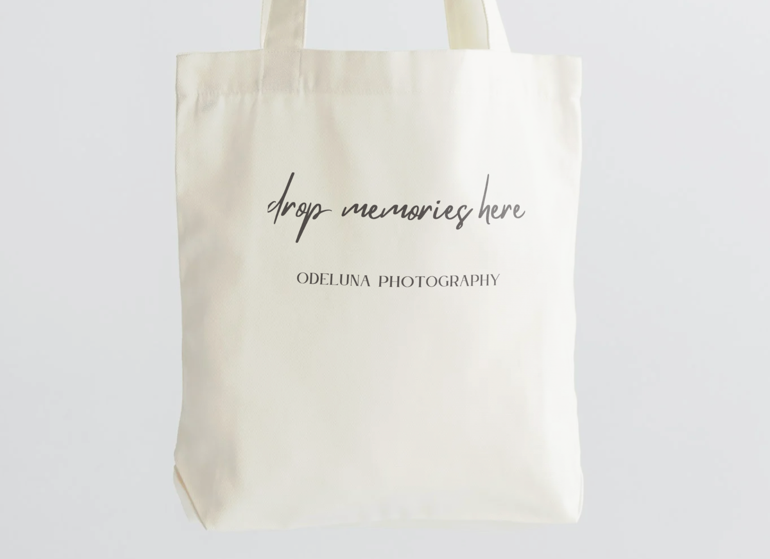 picture of a beige tote bag that says drop memories here odeluna photography