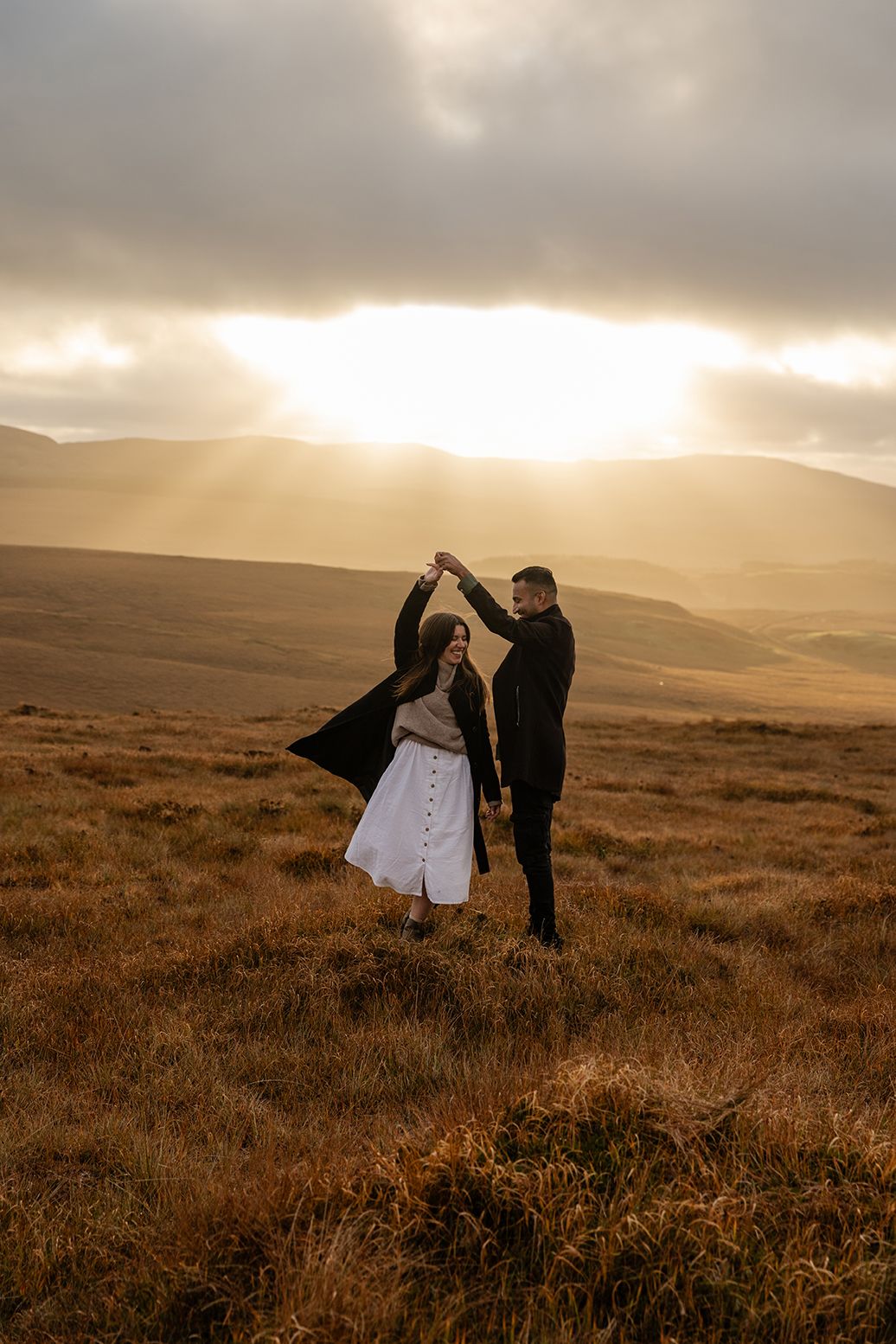 Couple dancing on Diamond Hill at sunset during a Connemara adventure session