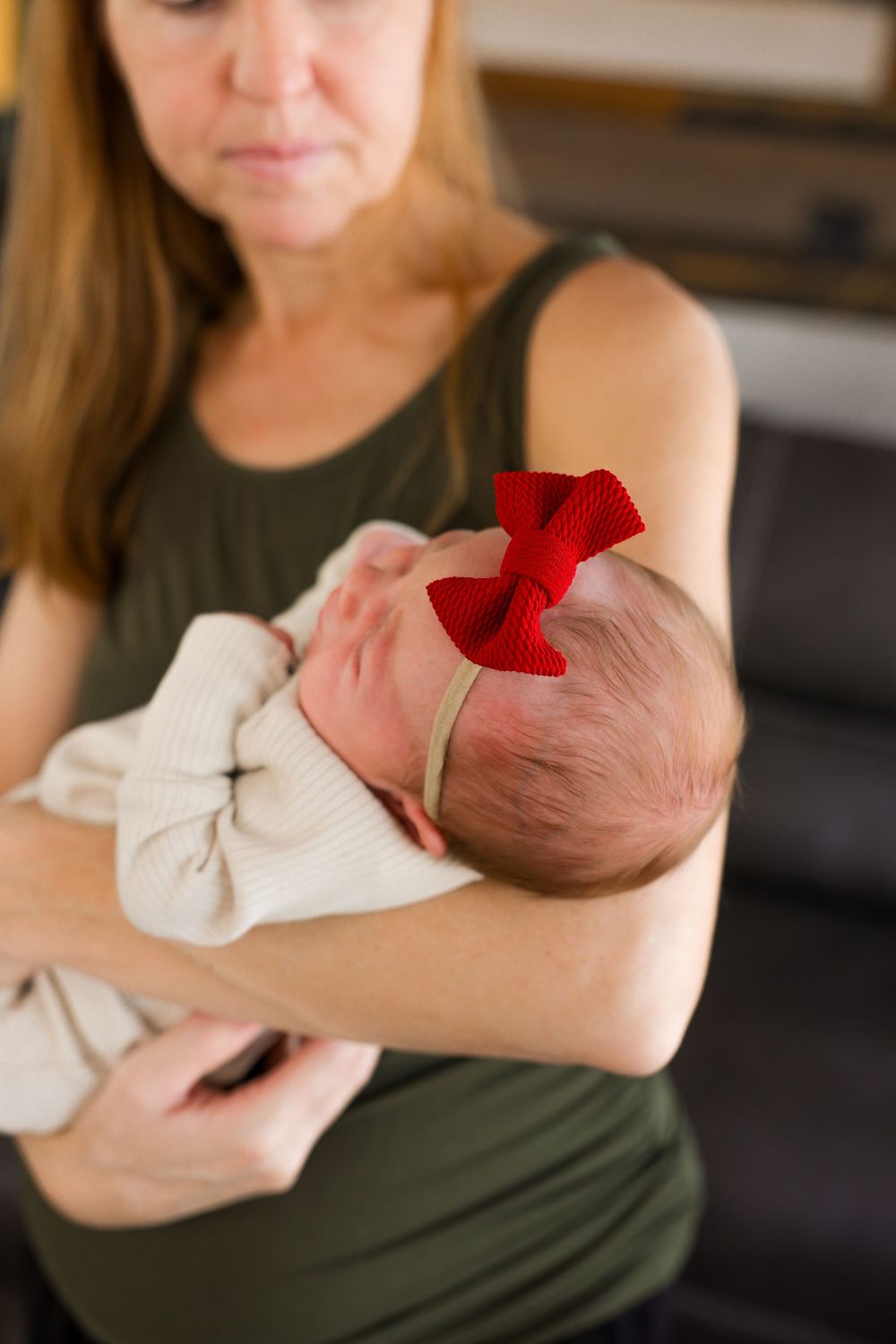Newborn photography in western Wisconsin, mom holding newborn baby.