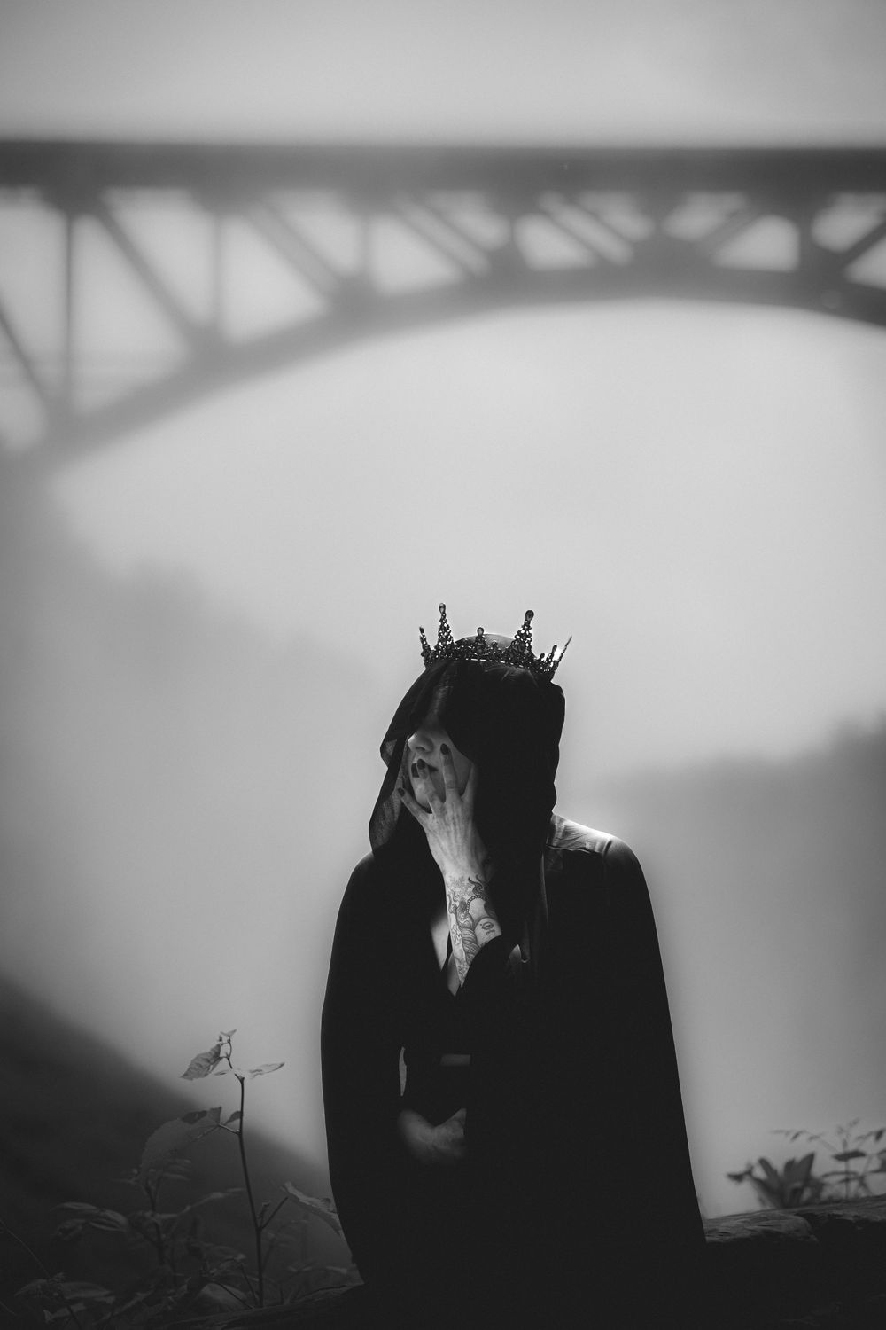 Artistic black and white silhouettes with crowns create a moody dramatic composition.