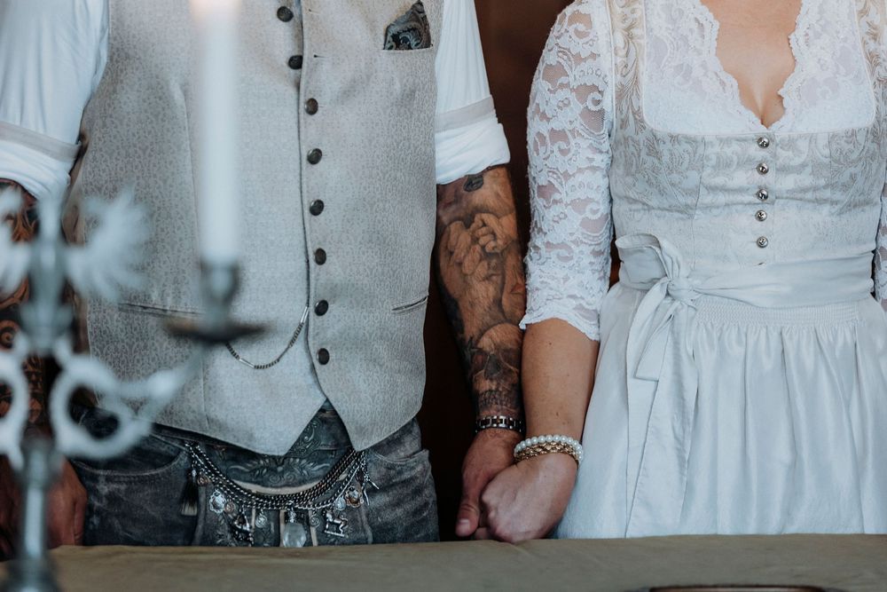 Detail shot of traditional Bavarian wedding attire with lace and buttons.