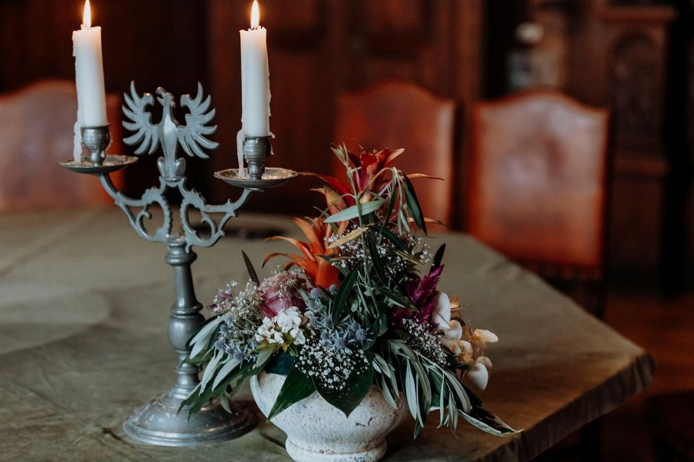 Elegant table decor with a blue candelabra and floral centerpiece.