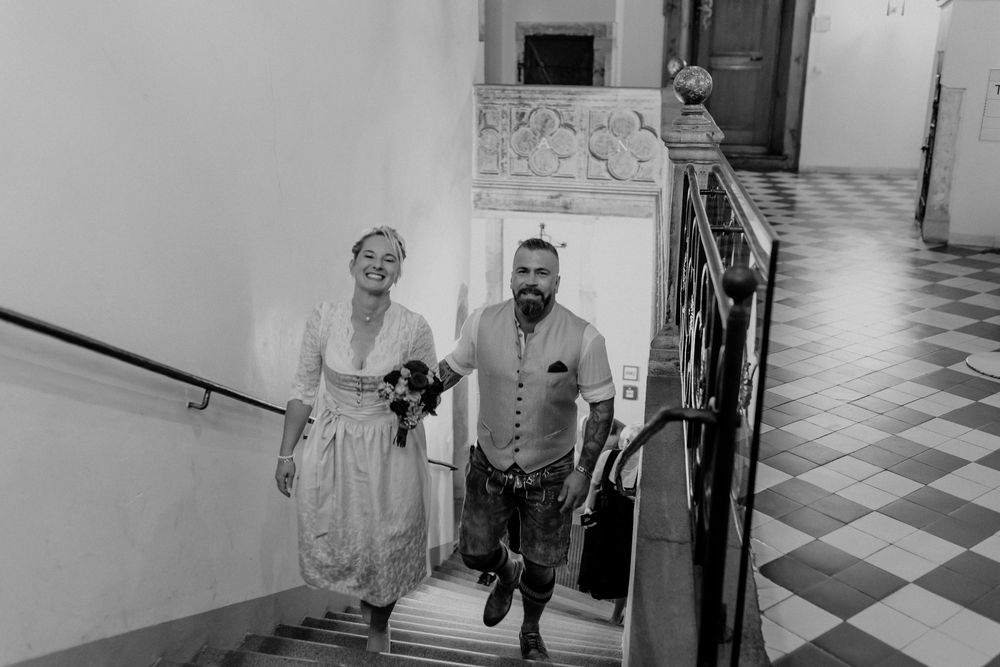 Candid moments captured in a hallway with checkerboard flooring.