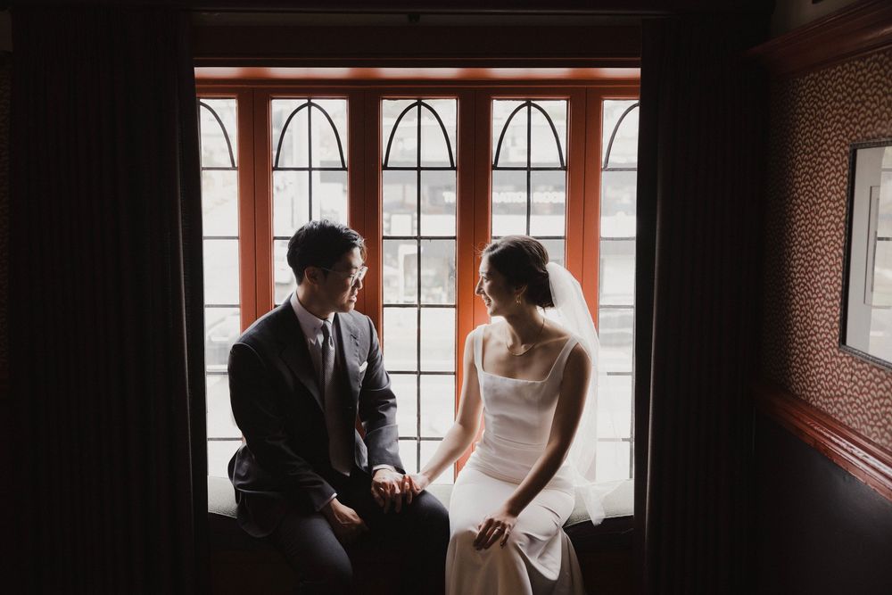 Romantic bride and groom portraits at Five Crowns in Corona del Mar, California with warm natural light.