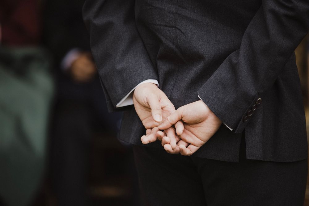 Couple exchanging rings during a Five Crowns wedding ceremony in Corona del Mar, California.