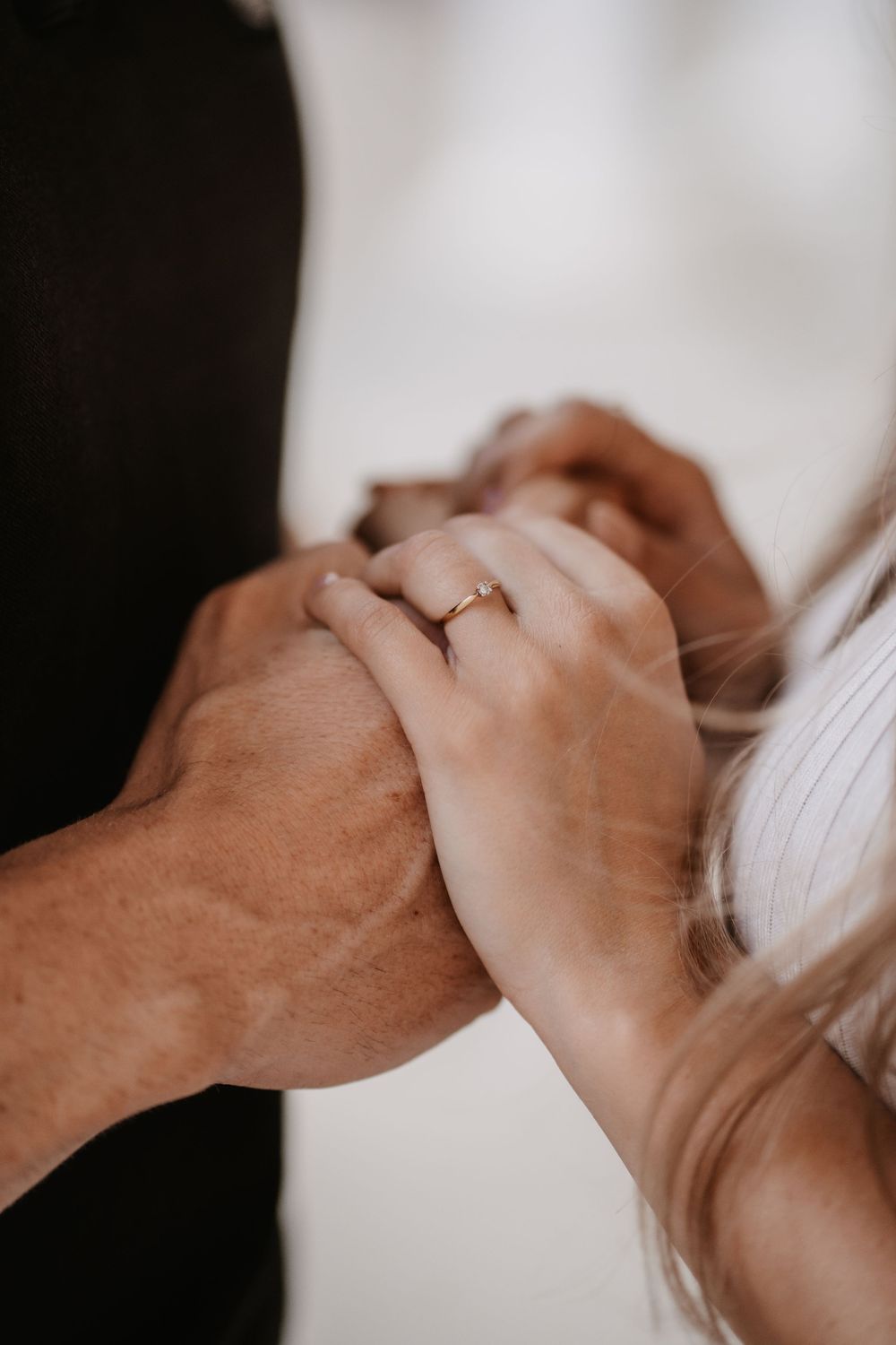 Intimate close-up photo series showing hands gently caressing and embracing in soft lighting.