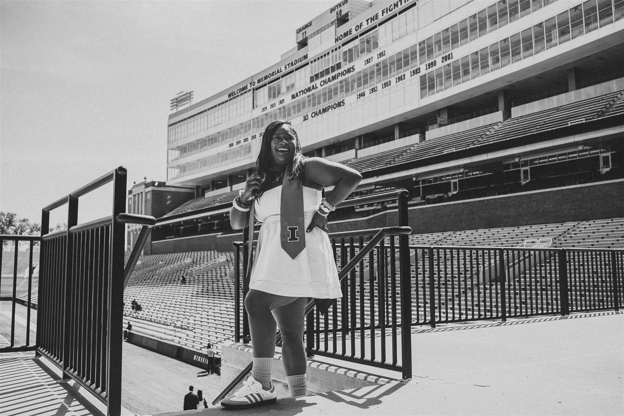 Black and white architectural photo of stadium seating and railings.