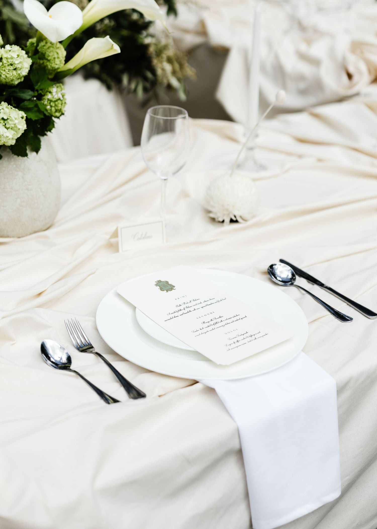 White linen napkins and elegant place settings arranged on a formal dining table with floral centerpieces in Adelaide