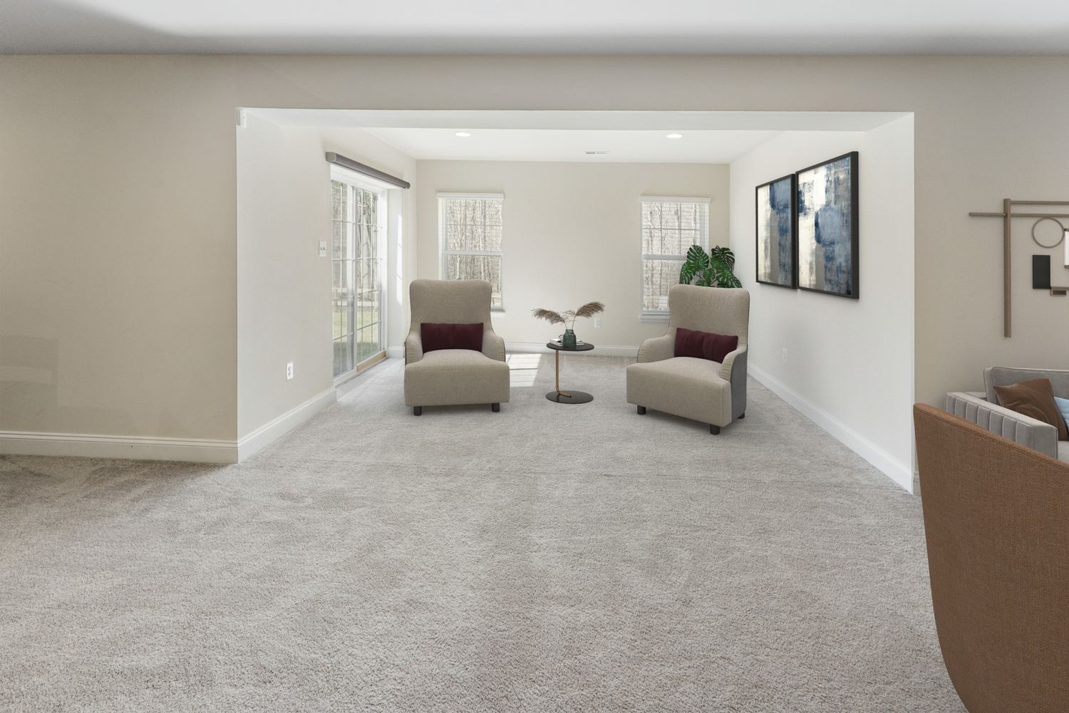 Large finished basement space with grey carpeting and recessed lighting throughout.
