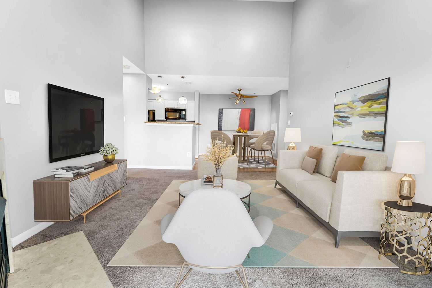 Contemporary living room with white sofa, geometric coffee table, and modern decor in neutral tones.