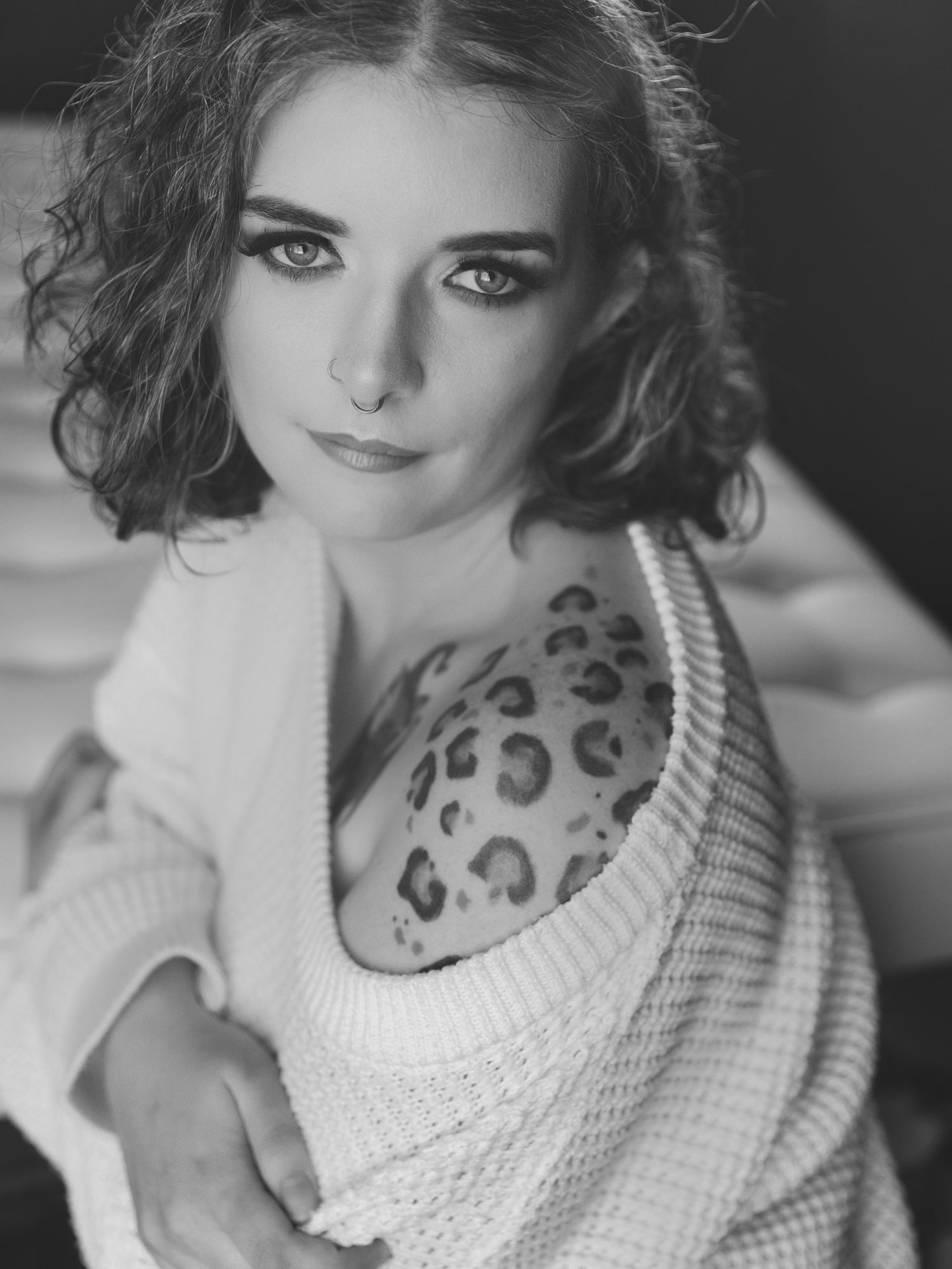 Classic black and white portrait with pearl necklace and elegant styling.