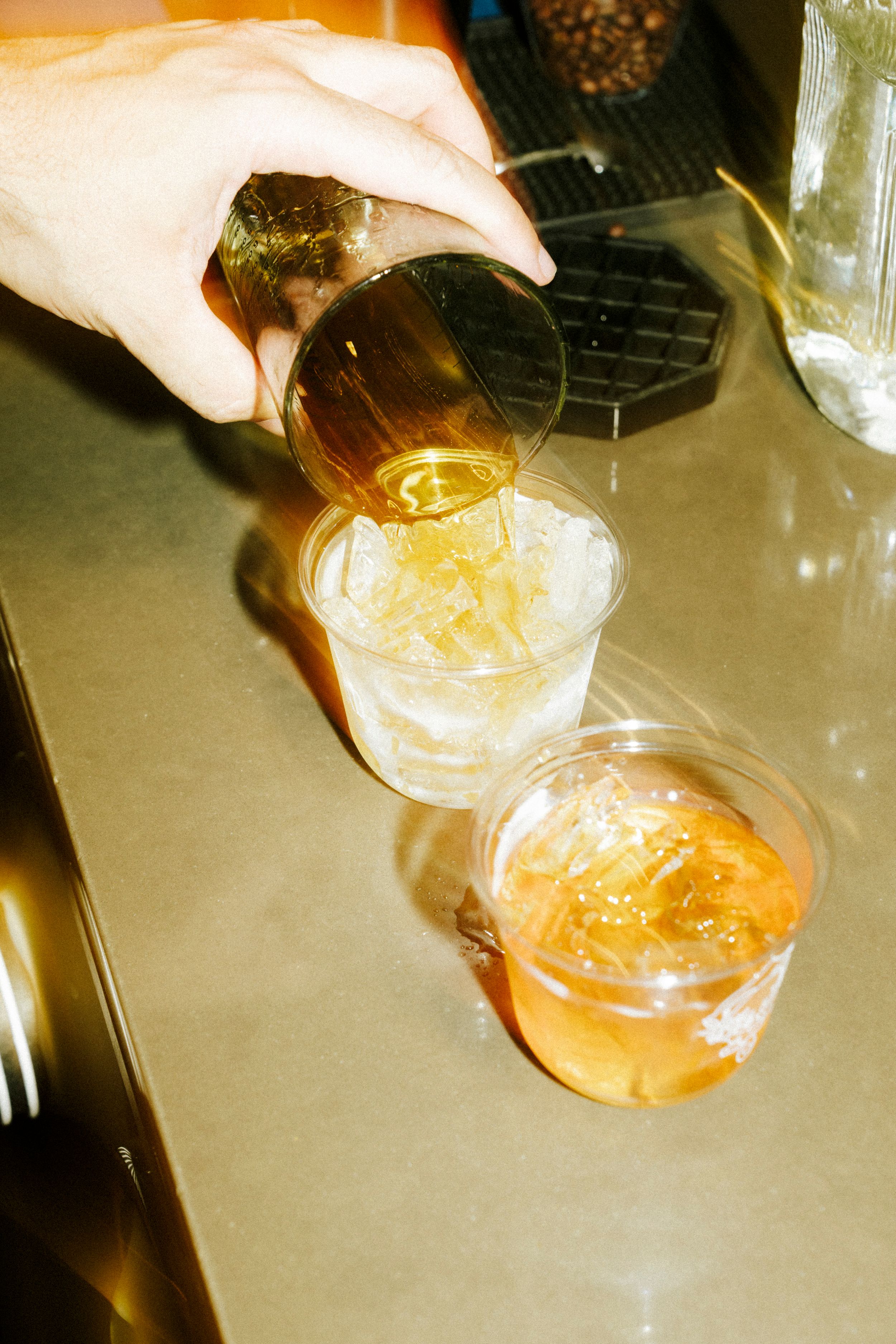 Multiple shots showing hands pouring golden liquid drinks in sequence from left to right.