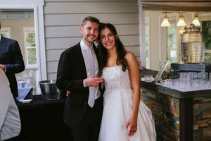 A couple shares a tender moment during their wedding reception at an elegant indoor venue.