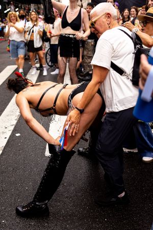 Queer New York City photography of annual dyke march attendees dancing by trans photographer Kade Joy.