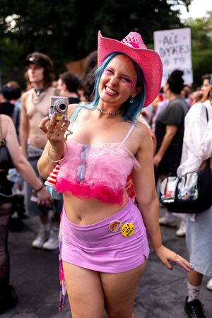 Photo of Brooke Finegold, Brooklyn based comedian, poet, collage artist and lesbian hands photographer at the New York City Dyke March.