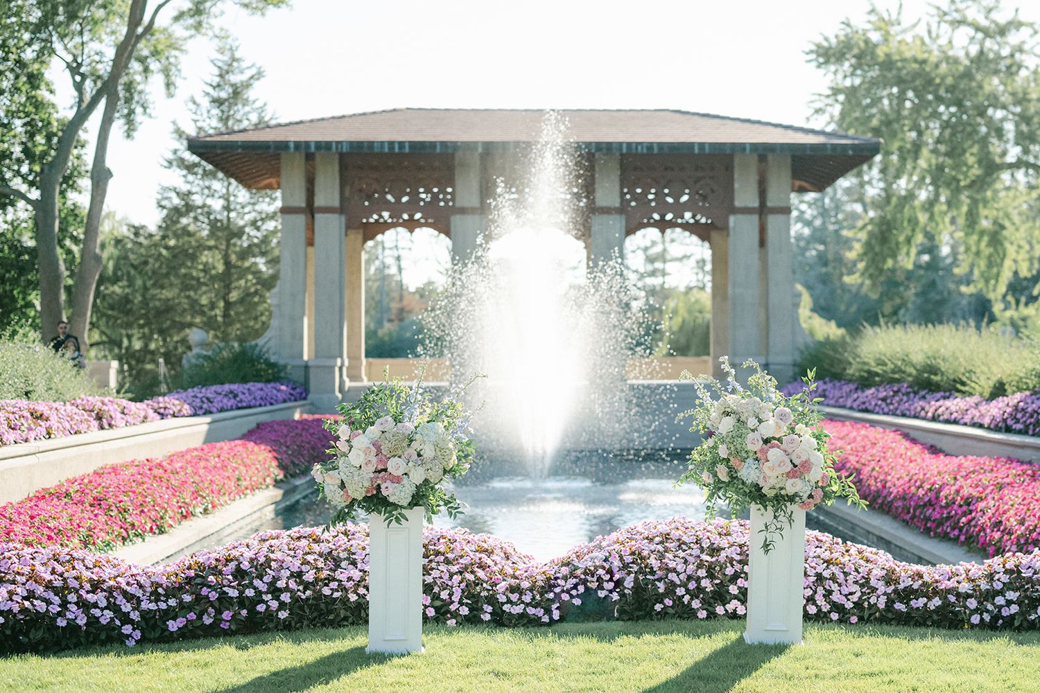 Armour House Wedding - Elegant garden wedding ceremony with a fountain centerpiece, floral arrangements, and a decorative gazebo.