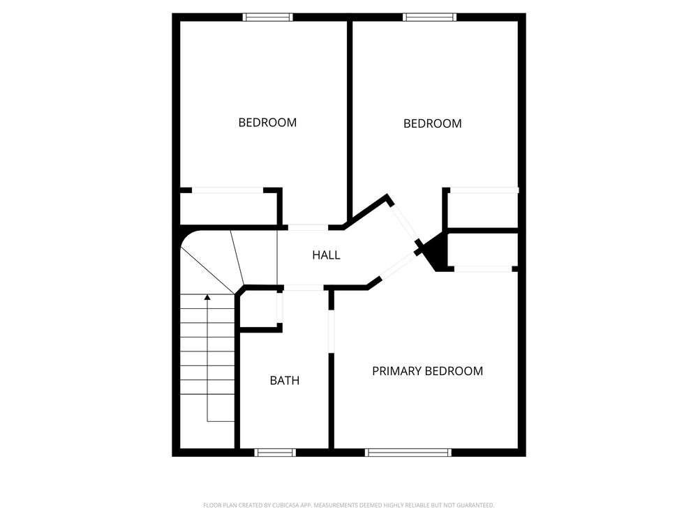 Upper floor plan featuring primary bedroom, two additional bedrooms, hall, and shared bathroom with staircase.