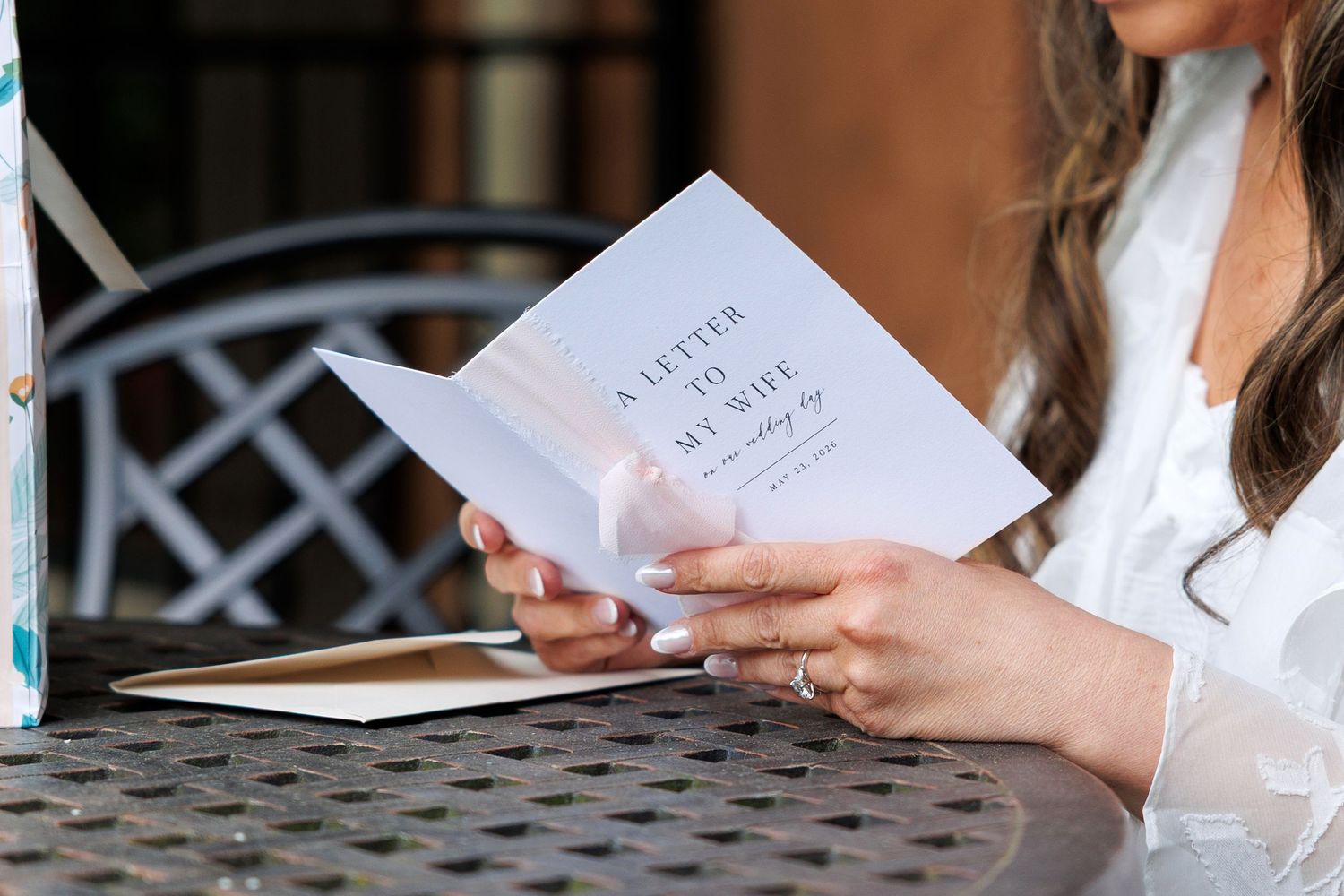 Bride reading letter from groom on wedding day  at Gervasi Vineyard in Canton, Ohio.