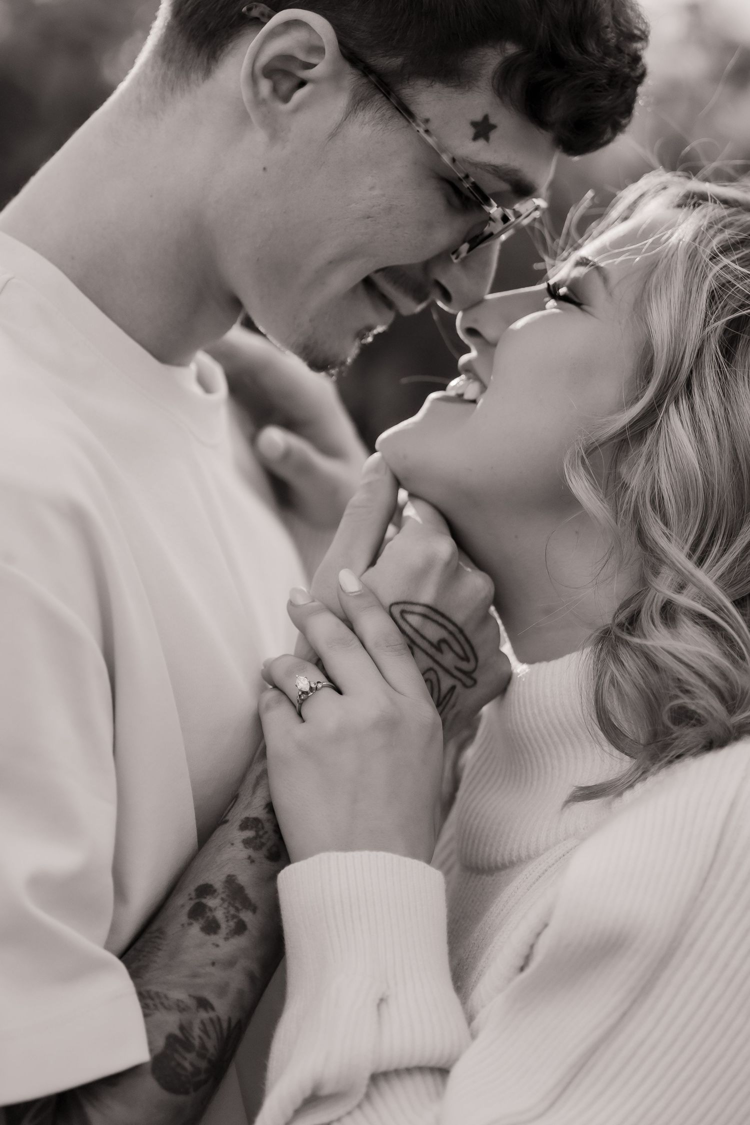 Intimate black and white portrait of couple sharing romantic moment.