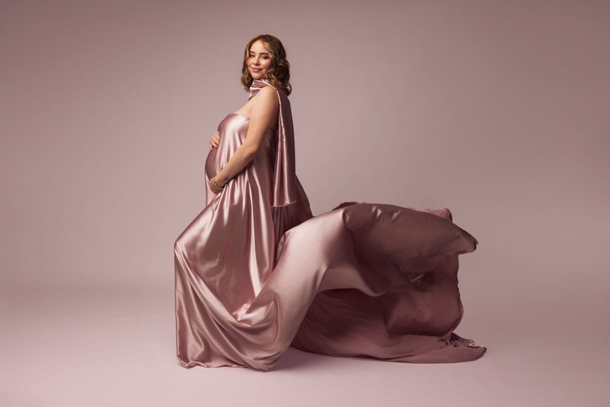 Professional maternity photography session with flowing fabric in Warkworth, capturing the beauty of pregnancy