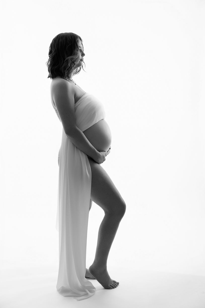 Professional maternity photography session in Warkworth, capturing the beauty of pregnancy in the backlit