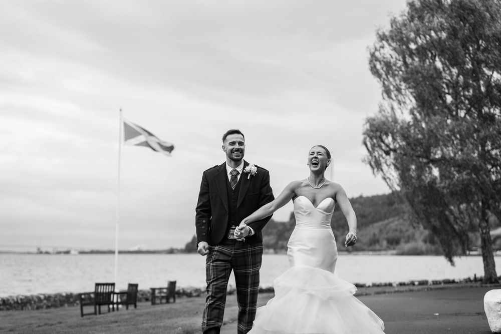 A series of black and white wedding photos showing romantic moments between a couple outdoors by the water.