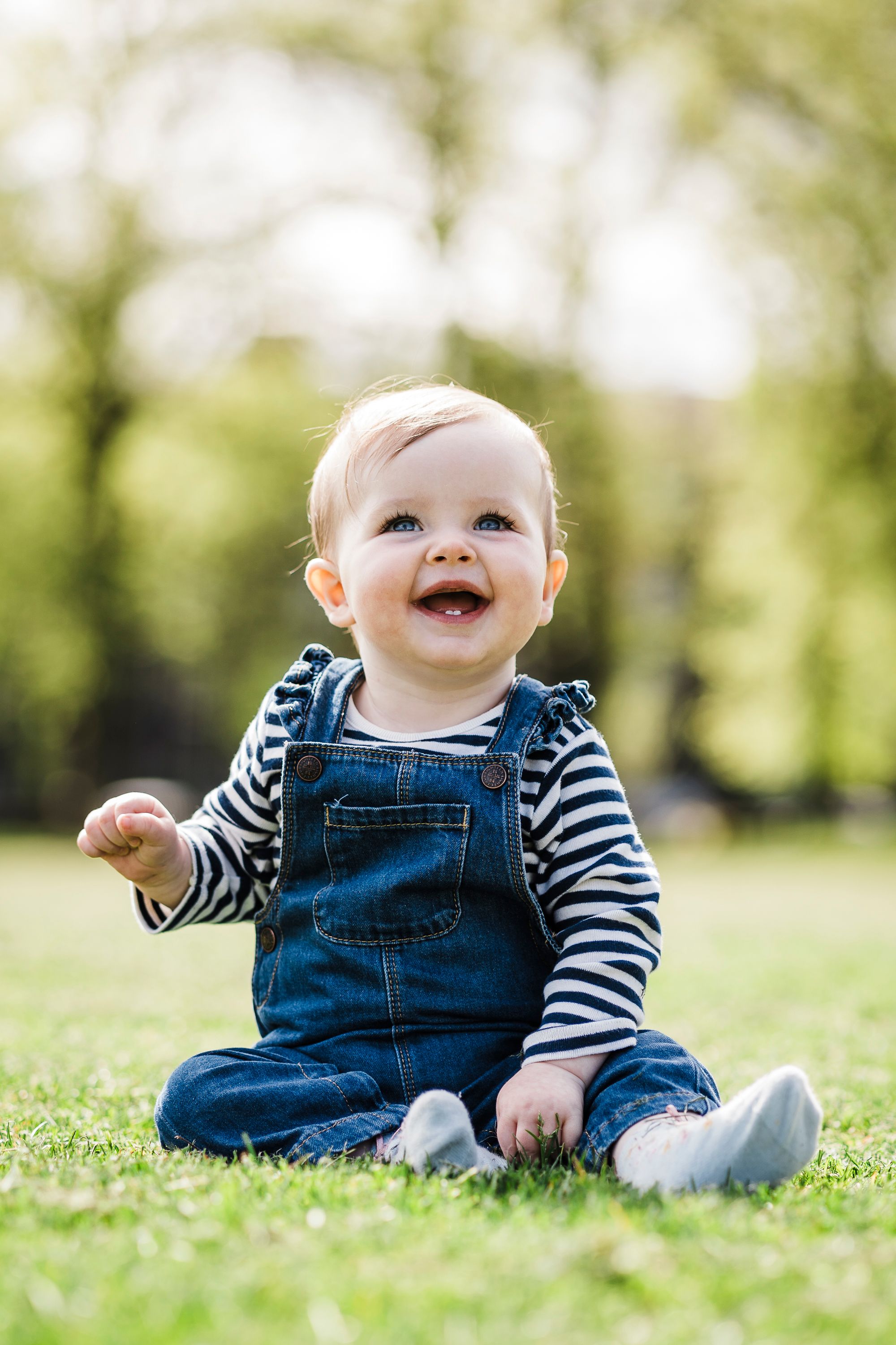 Baby sitting in Baxter park Dundee, laughing