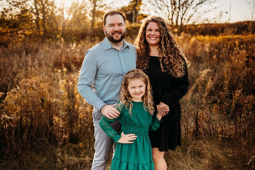 Candid family portraits captured in warm golden hour lighting outdoors.