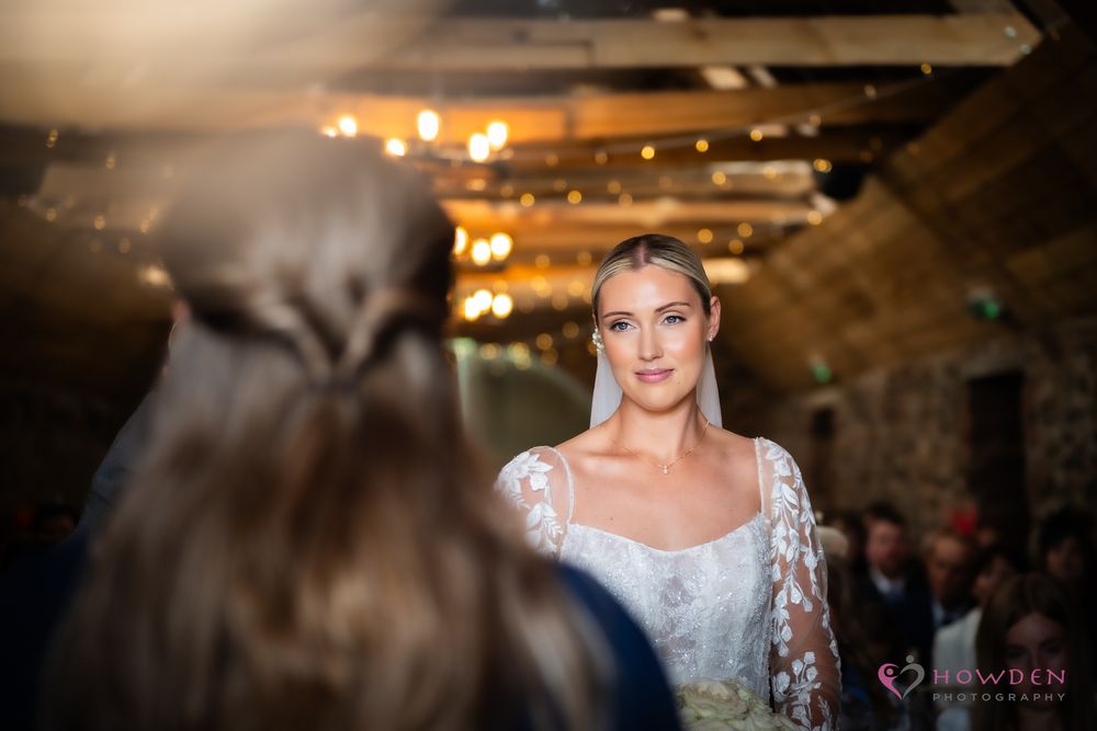 Blurry dance floor movement at a wedding reception with warm glowing lights and multiple figures captured in motion.