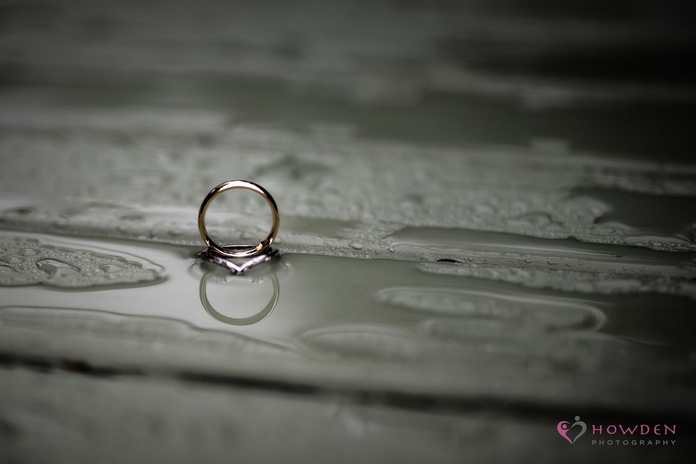 Seven sequential macro photographs of wedding rings with reflective surfaces on textured backgrounds create an artistic composition.