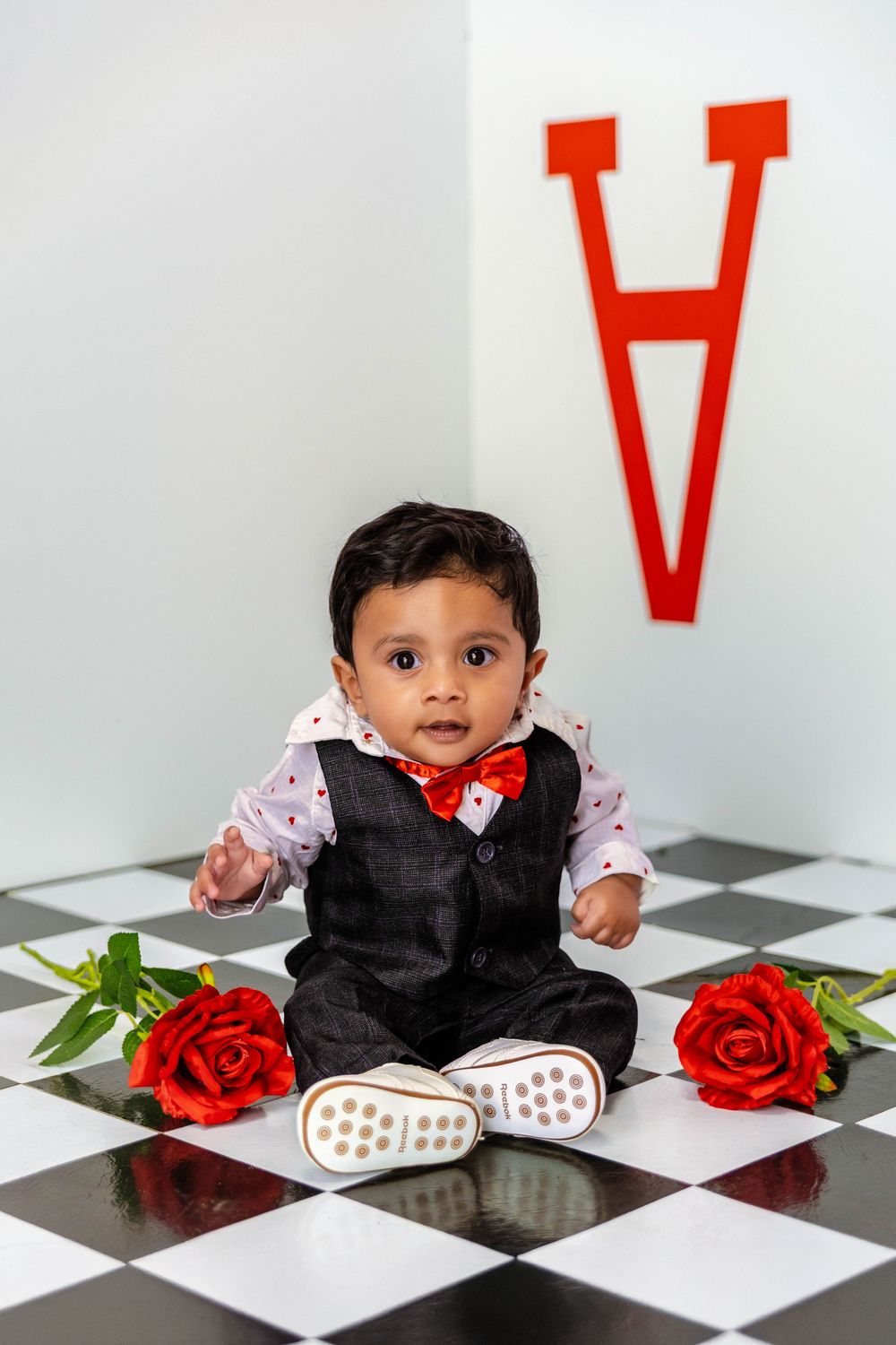 A little boy poses on a Valentines Day Studio set.