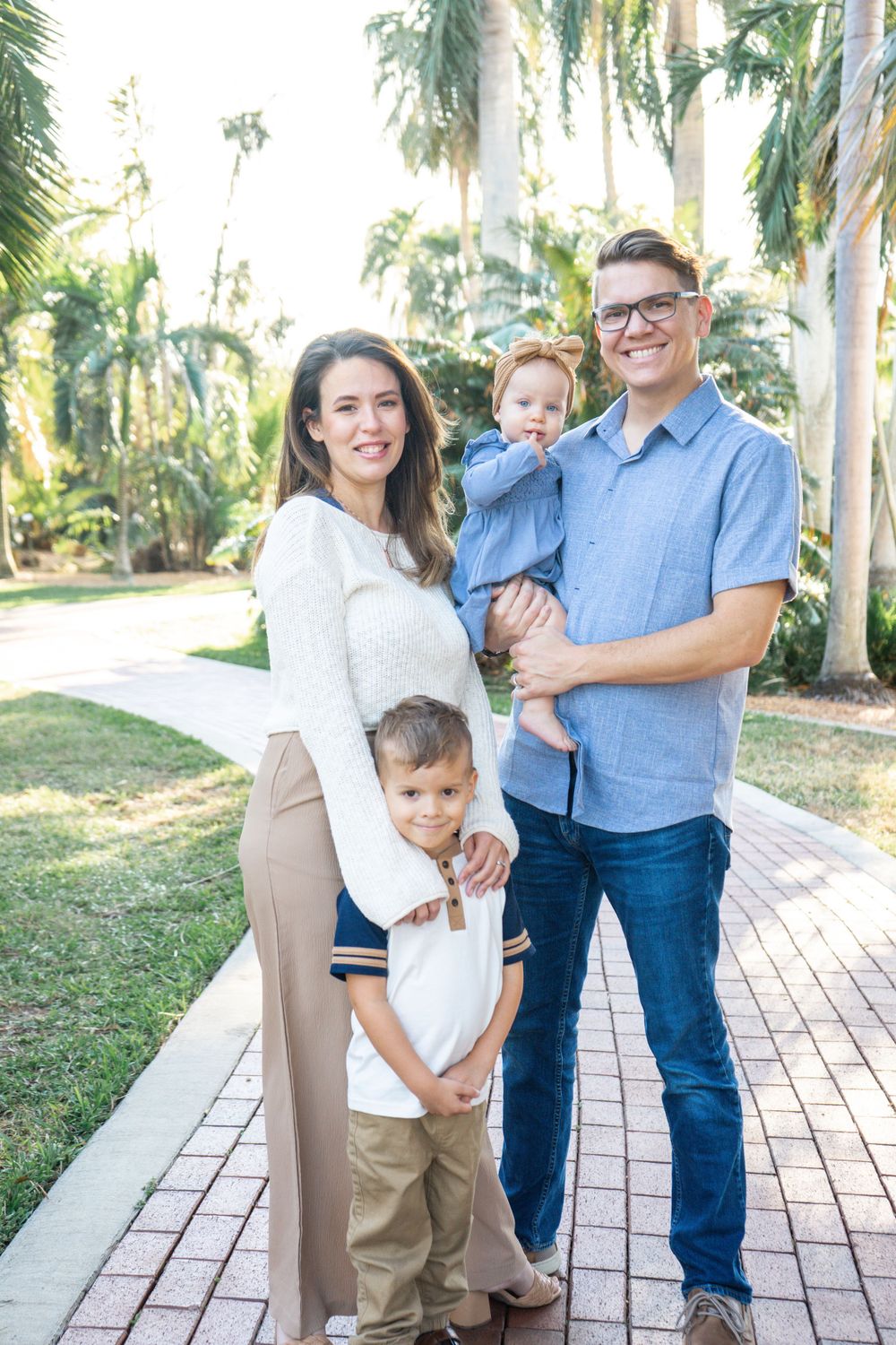 Outdoor Family Session Gisela Kopsick Arboretum in Saint Petersburg, FL; Family posing together on brick path