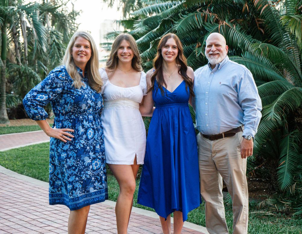 Outdoor Family Session Gisela Kopsick Arboretum in Saint Petersburg, FL; Family posing together in front of palm fronds