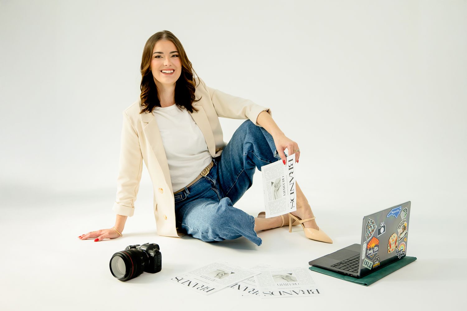 Lifestyle photography session with laptop and casual attire on white background.