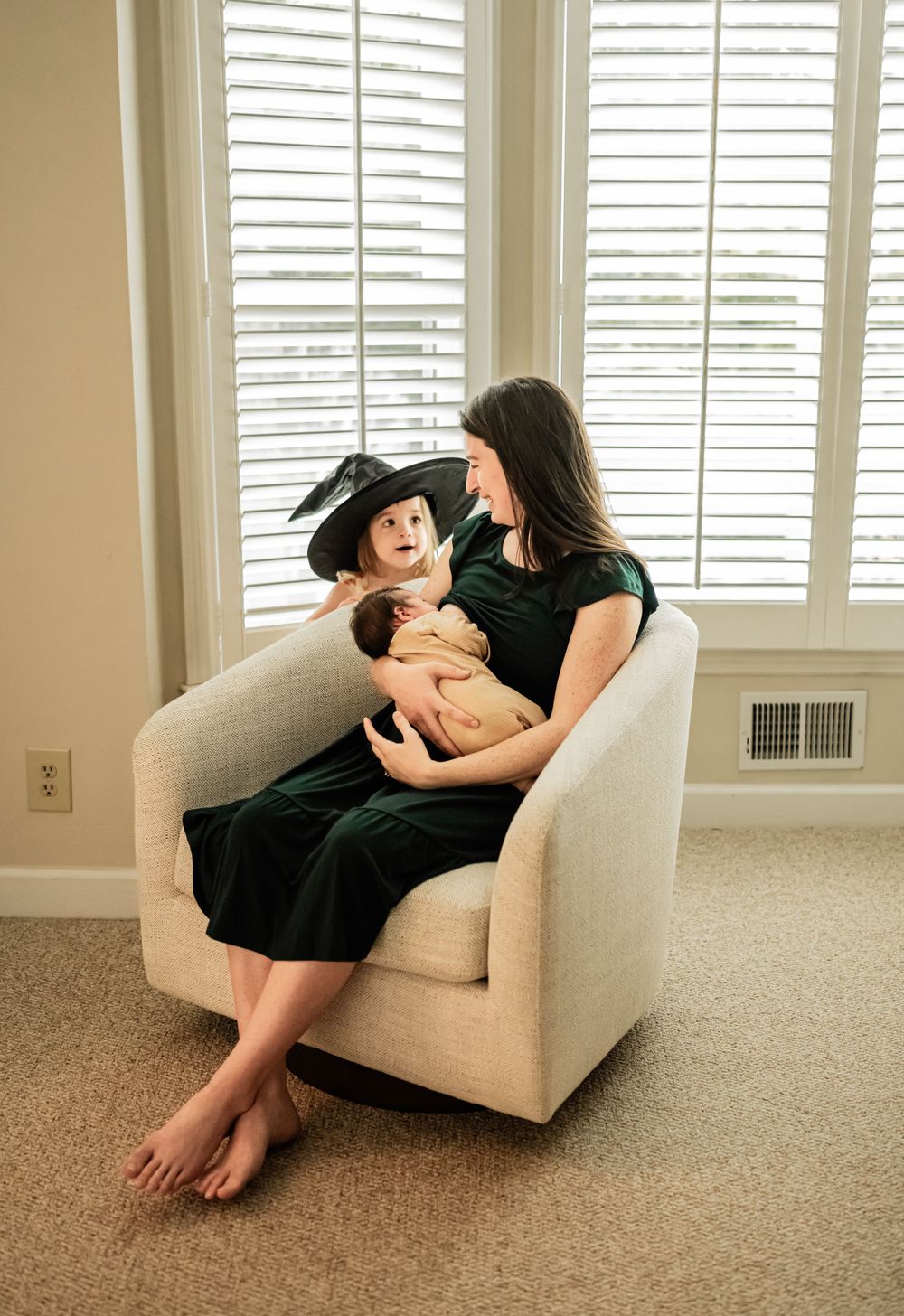 Relaxing moment in a bright room with shuttered windows and cream armchair.