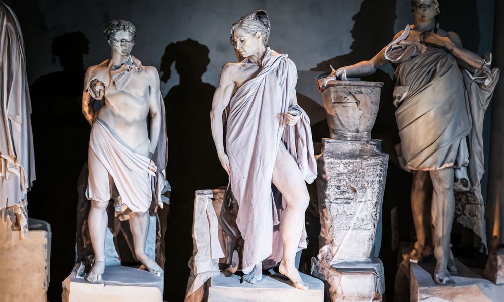 Ancient Roman marble statues displayed in a museum setting.